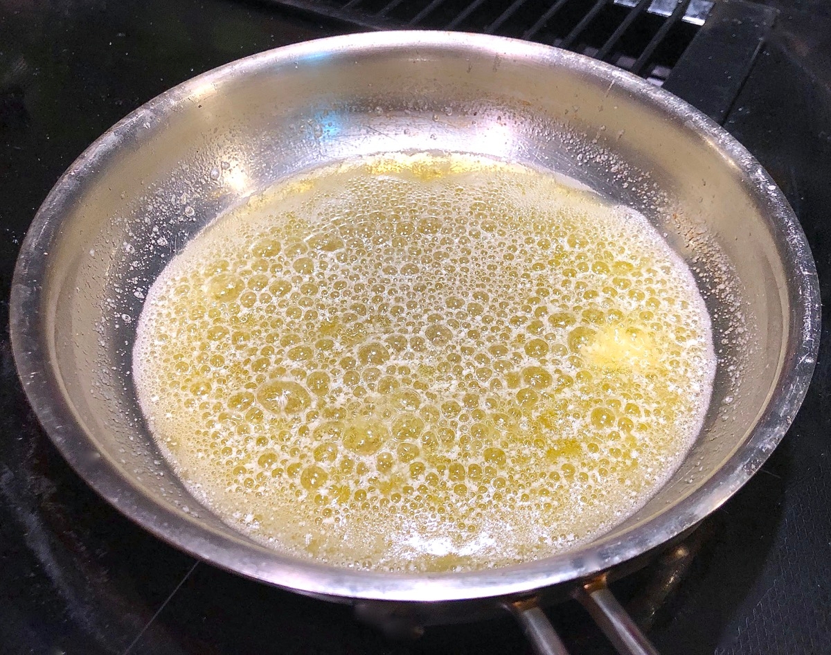 Butter sizzling in a shallow skillet.