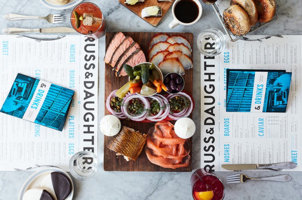 Overhead view of Russ and daughters menu and smoked fish platter