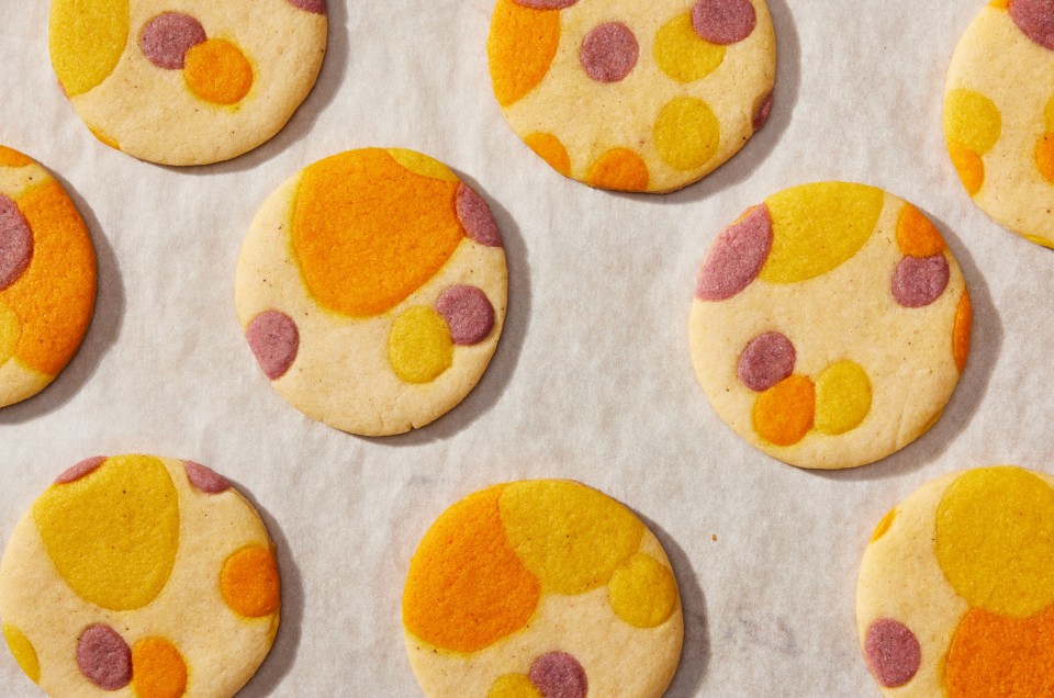 Printed sugar cookies on a piece of white parchment paper.