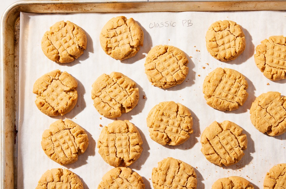 Freshly baked Classic Peanut Butter Cookies on a sheet pan - select to zoom