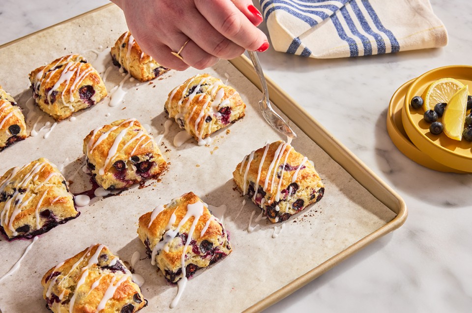 Blueberry Biscuits with Lemon Glaze being applied - select to zoom