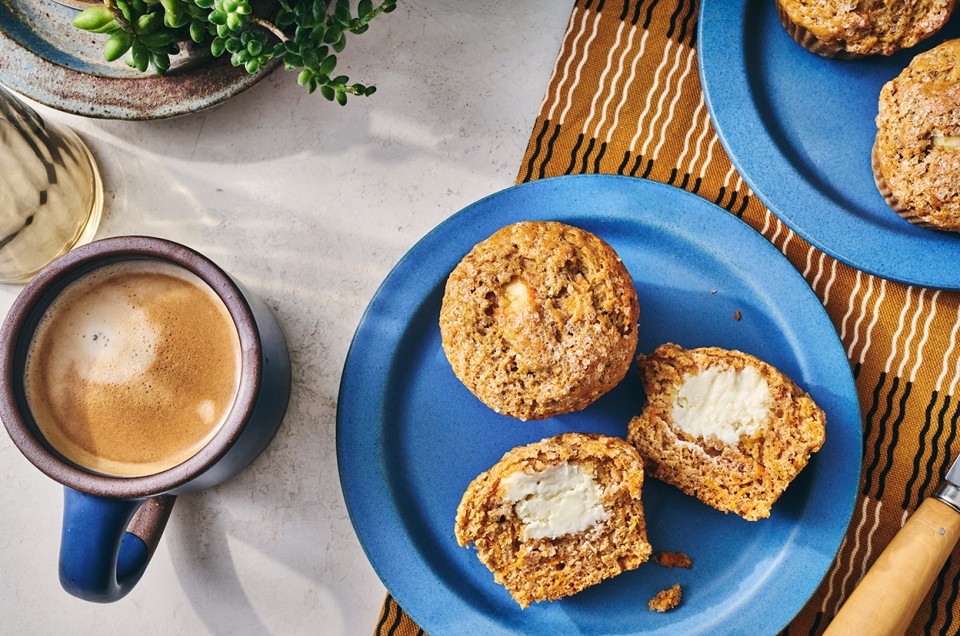 Cream Cheese Carrot Cake Muffins on a plate with a cup of coffee - select to zoom