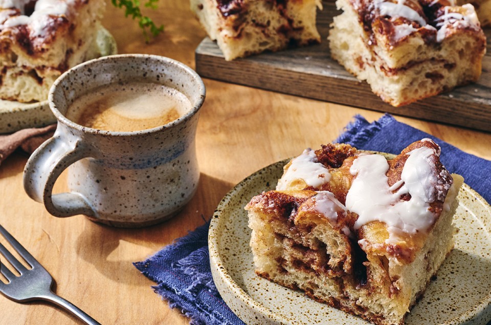 Cinnamon Roll Focaccia on a plate with a cup of coffee - select to zoom