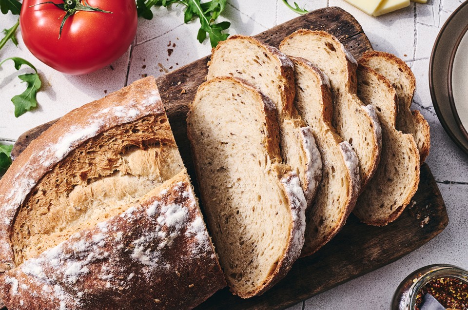 Caraway Rye Bread sliced on a cutting board - select to zoom