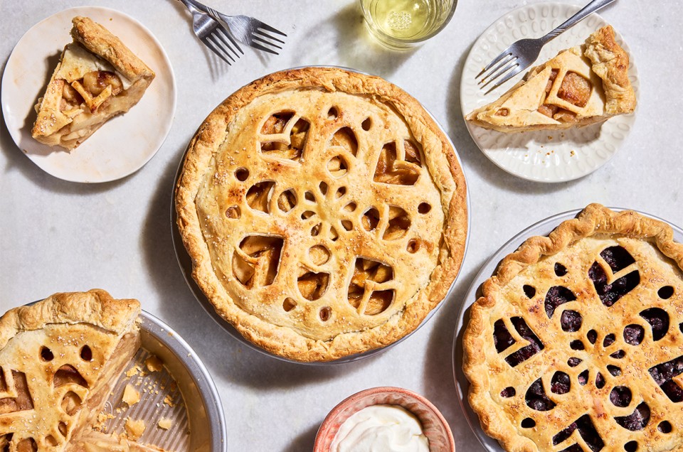 Three Apple Pie with Make-Ahead Filling in pie pans and two slices on plates - select to zoom