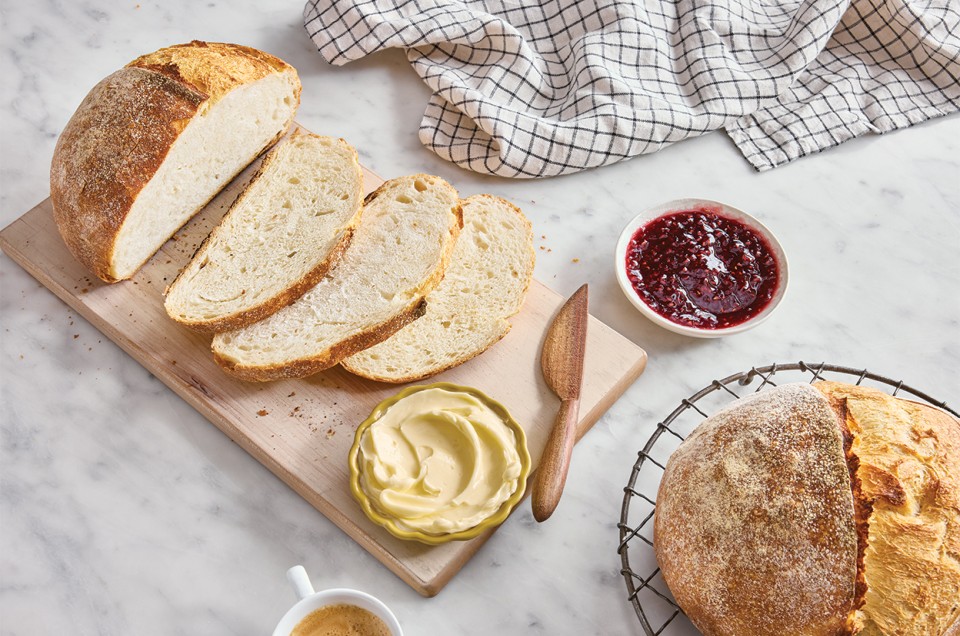 Extra-Tangy Sourdough Bread sliced on a cutting board - select to zoom
