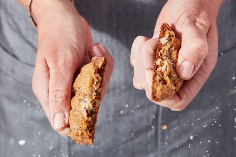 A Salty-Sweet Butter Pecan Cookie being snapped in half.