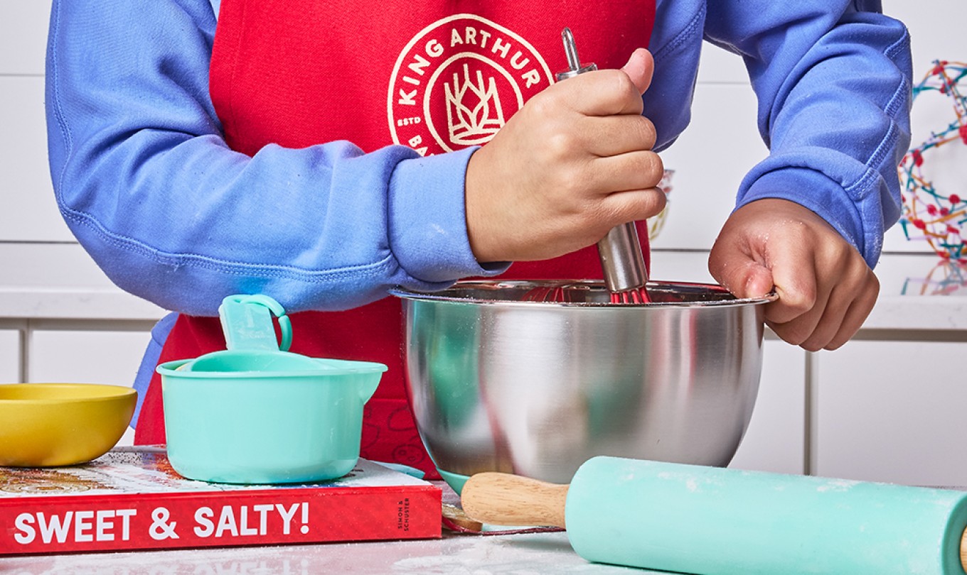 A little boy mixing batter