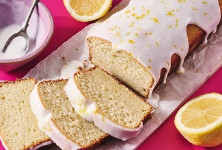 Glazed Sourdough Lemon Cake sliced up on parchment paper