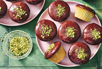 Pistachio-Cardamom Cupcakes with Dark Chocolate Ganache on a plate