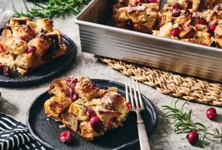Cranberry-Rosemary Breakfast Bread Pudding on plates and in a pan.