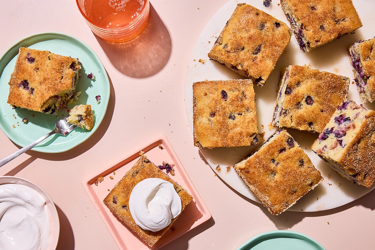Easy Blueberry Muffin Cake served on a plate with whipped cream