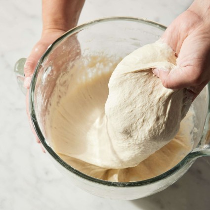 Bread dough being folded by hand
