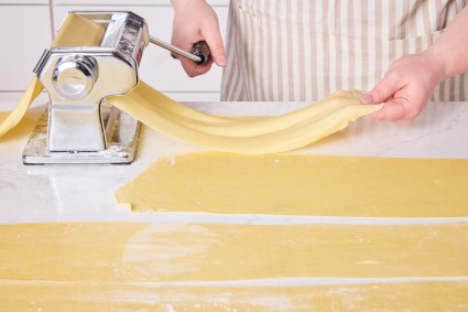 Rolling out egg noodles in a pasta machine