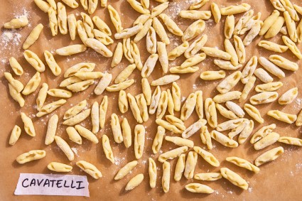 Cavatelli pasta shape on a parchment-line baking sheet