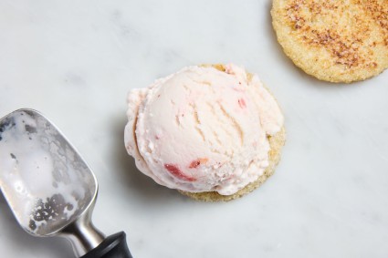 Scoop of strawberry ice cream on a round of sandwich bread to make ice cream sandwiches